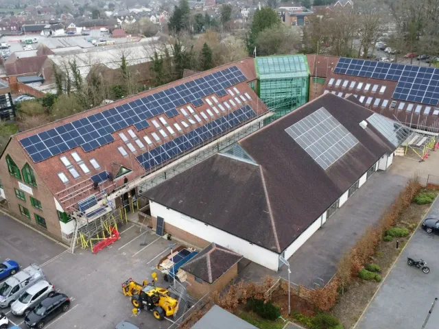 Commercial Solar Panel Installation in Dorset Aerial view of a commercial solar panel installation on a large roof in Dorset by Up Top Solar