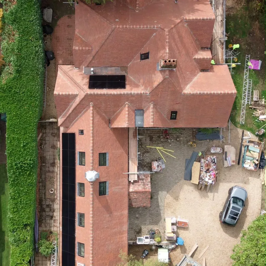 Close aerial view of the handmade clay tile roof, hips and roof windows at Dover Road, with scaffolding still in place