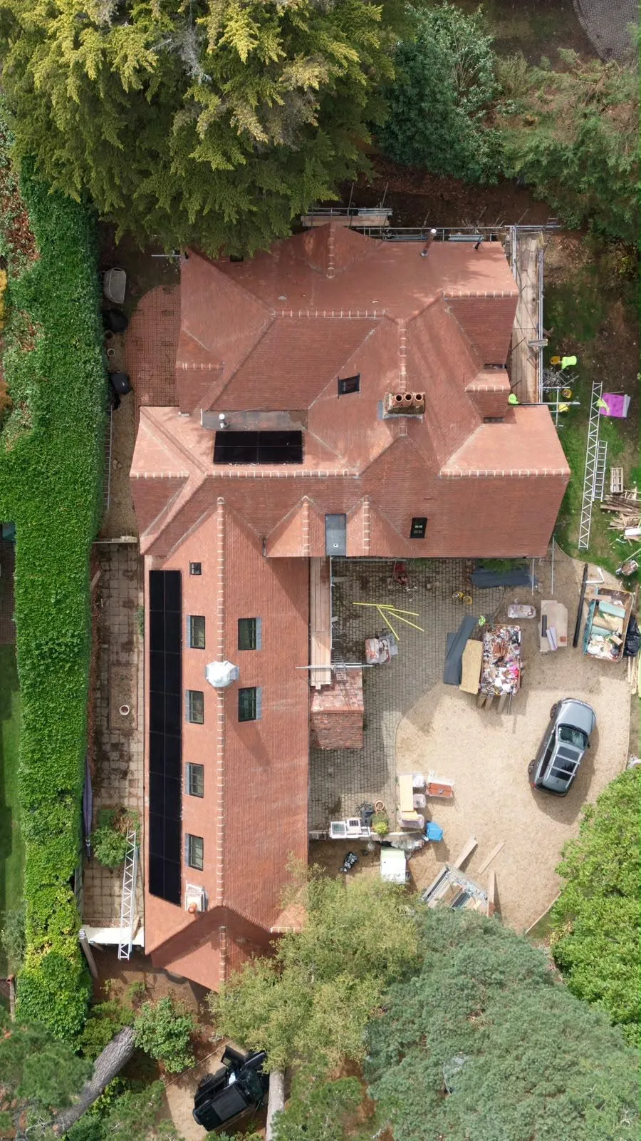 Close aerial view of the handmade clay tile roof, hips and roof windows at Dover Road, with scaffolding still in place