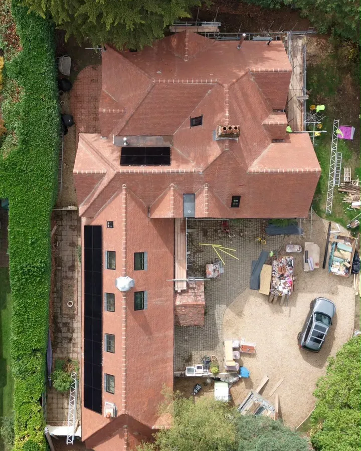Close aerial view of the handmade clay tile roof, hips and roof windows at Dover Road, with scaffolding still in place