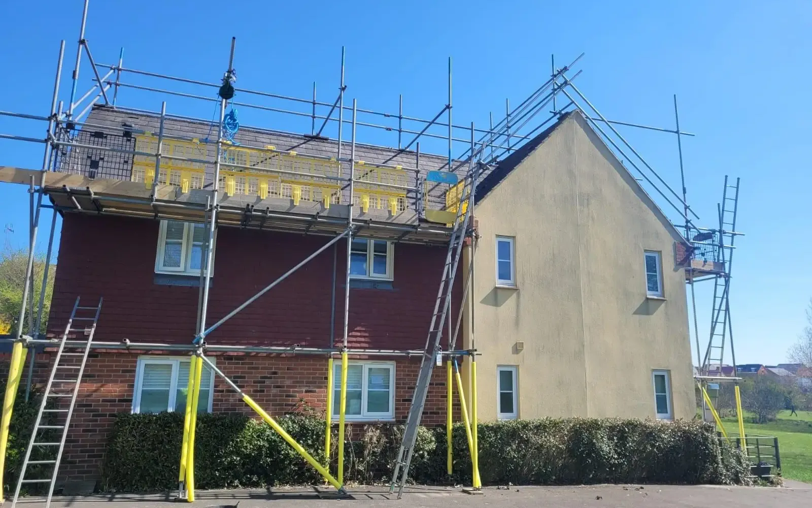Up Top Roofing team working from safe scaffold access on a roof project
