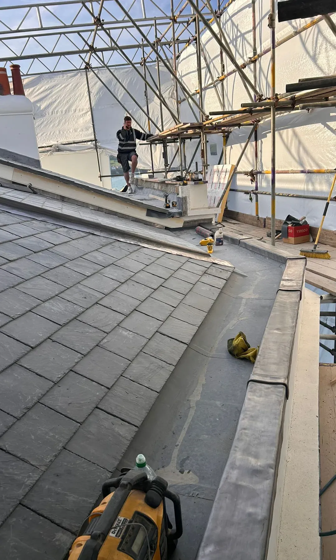 Lead-capped copings and parapet gutter detailing on a Swanage slate roof