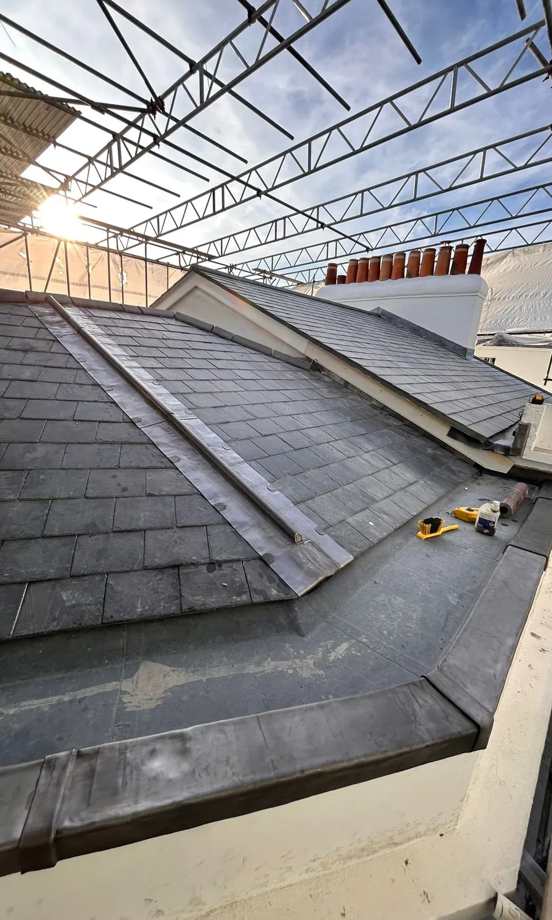 Natural slate roof in Swanage with lead mop roll ridge and scaffold access