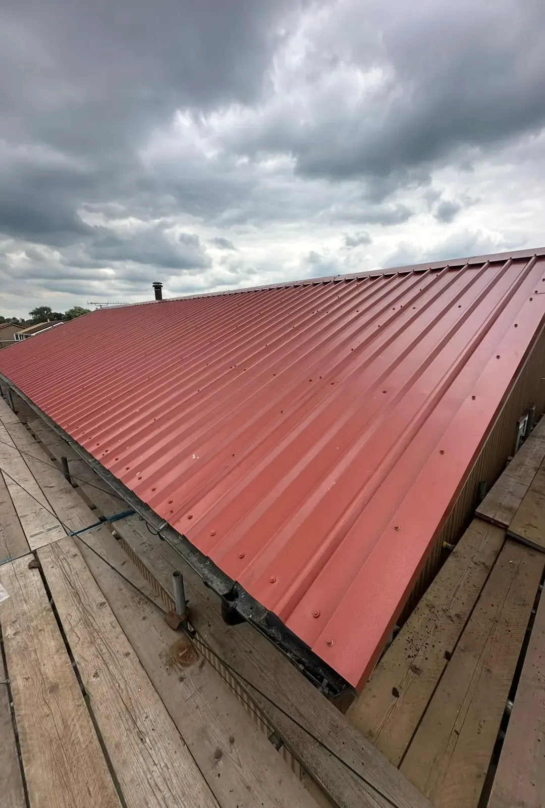Profiled sheet commercial re-roof in Bournemouth BH1 with red steel sheets
