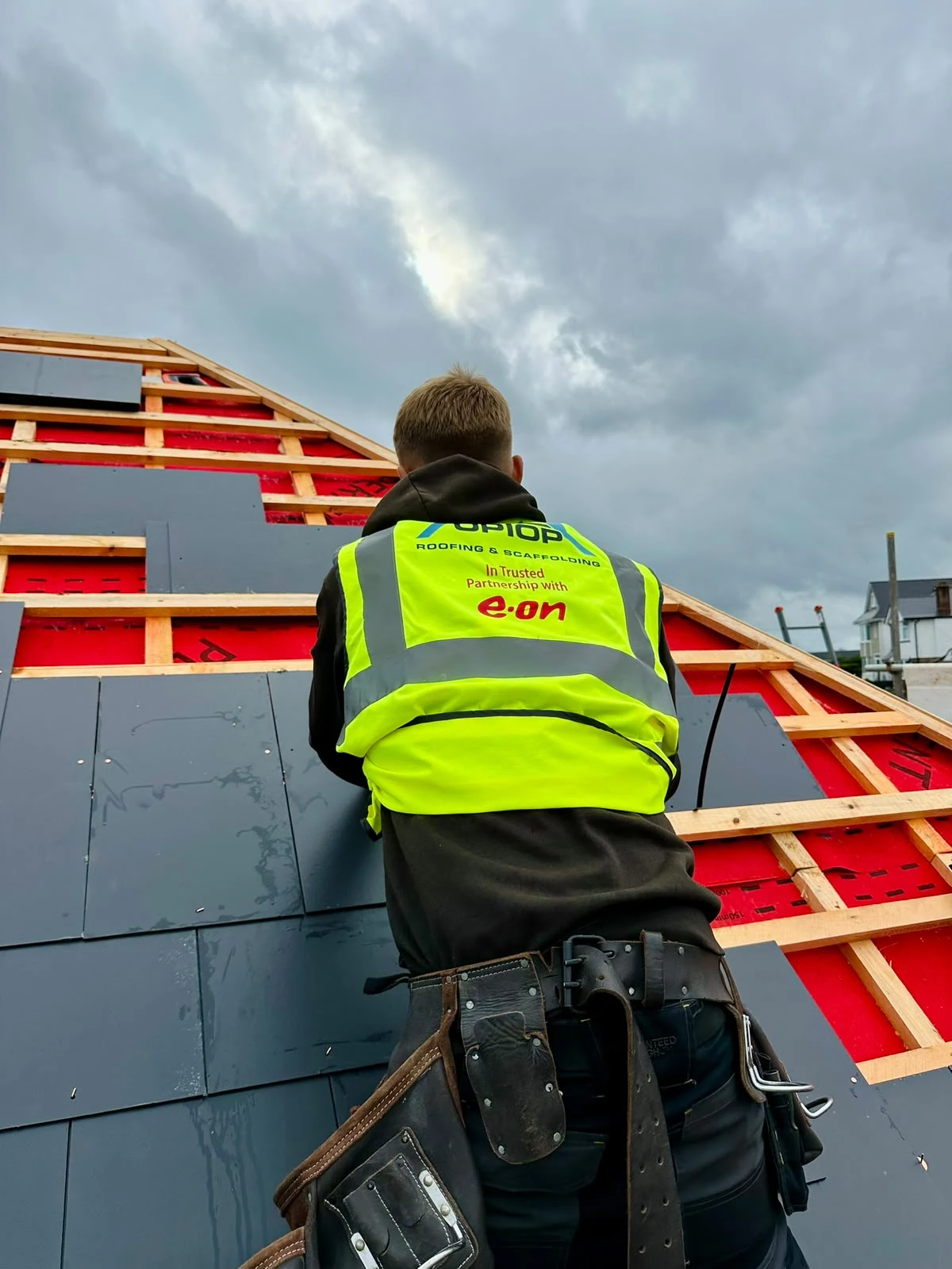 Up Top Roofing installer fitting slate on a new roof installation in Dorset
