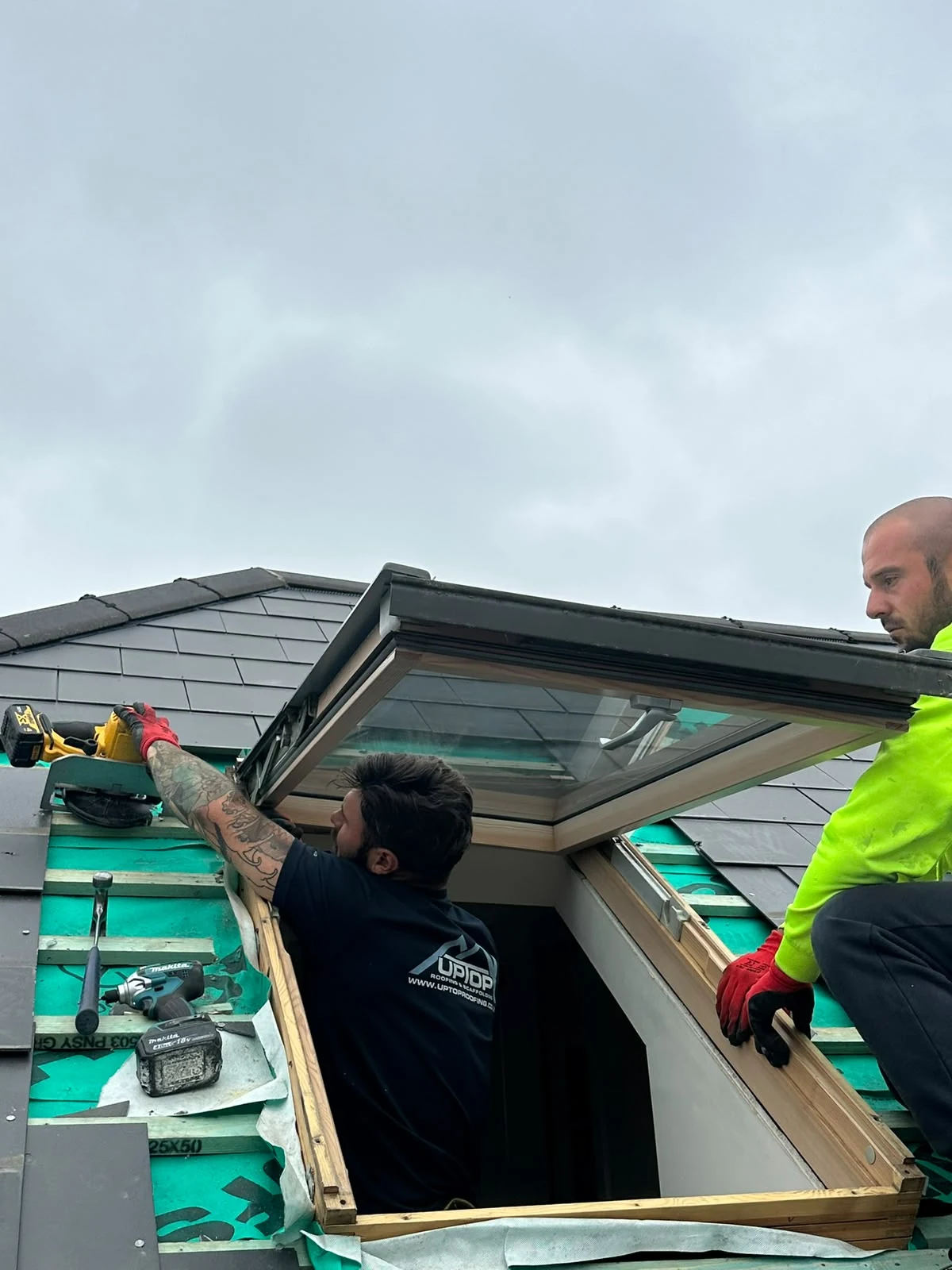 Up Top Roofing team installing a roof window on a Dorset property